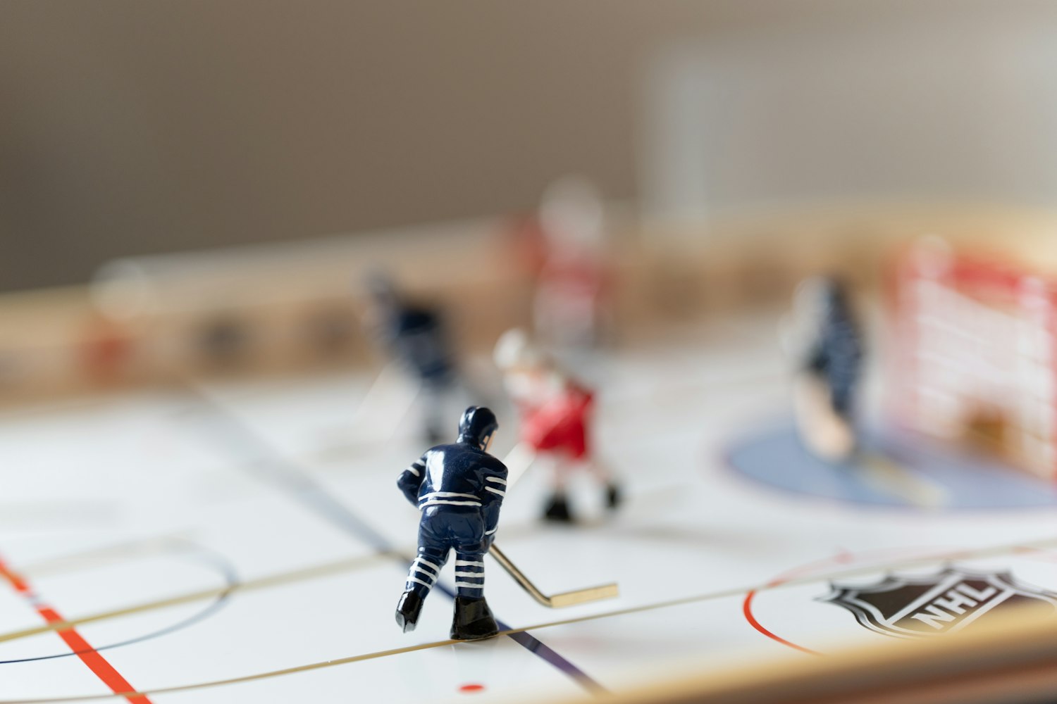Three neutral planning markers beside unbranded ice hockey jerseys