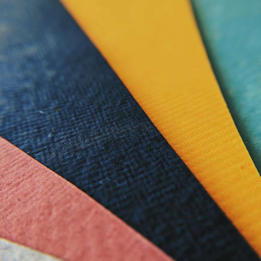 Panels of different apparel fabrics lying across one another so the overlap is visible