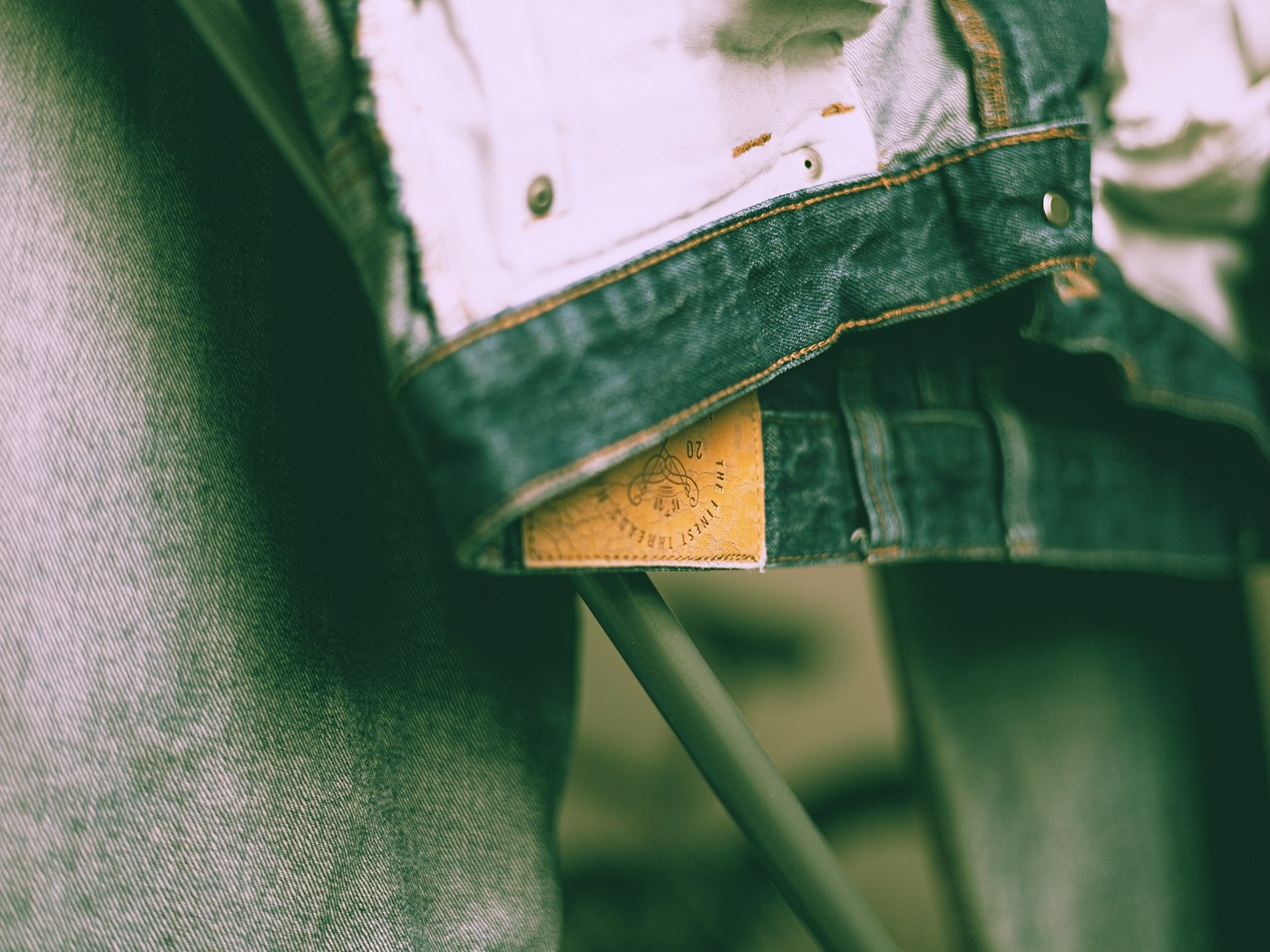 A label sewn into the waistband of a garment, carrying the maker's own mark
