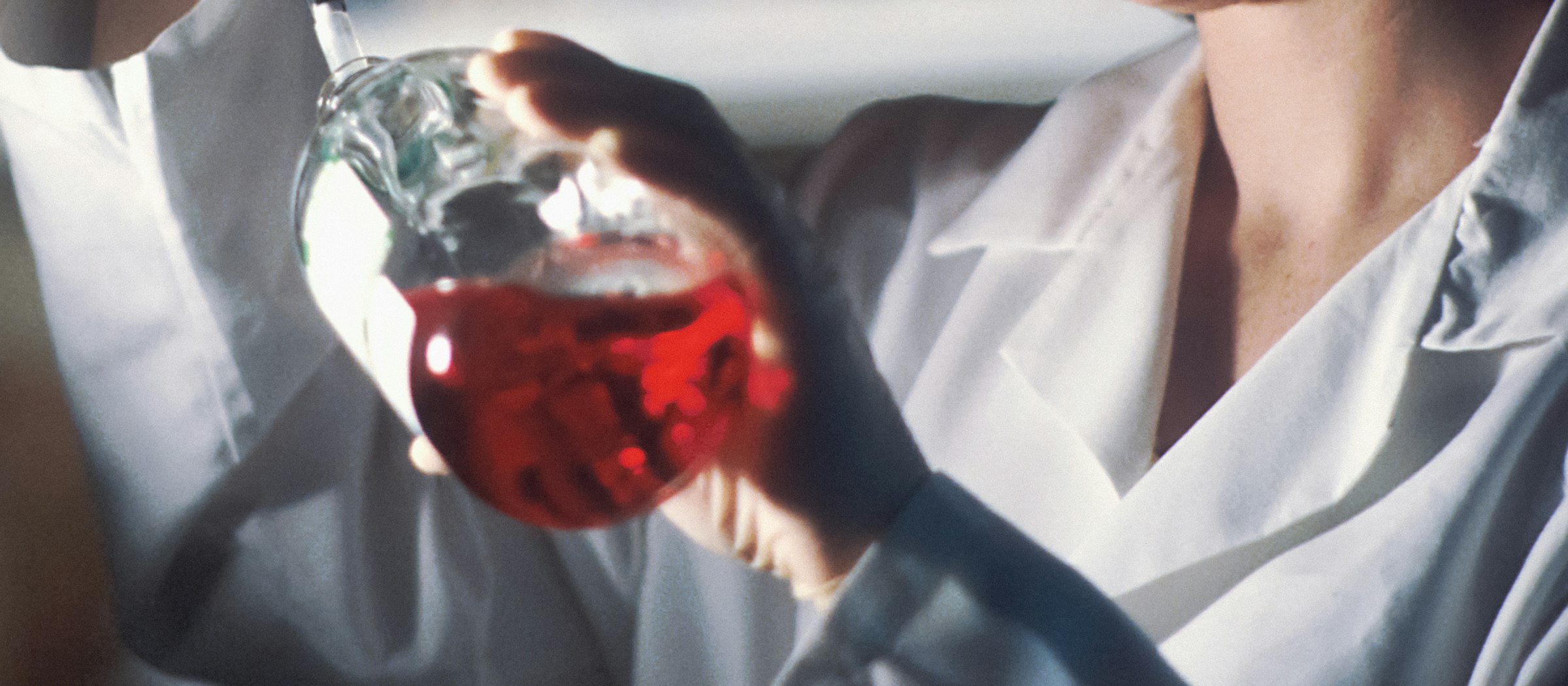 A third-party laboratory technician running a color fastness test on a hockey sock fabric sample