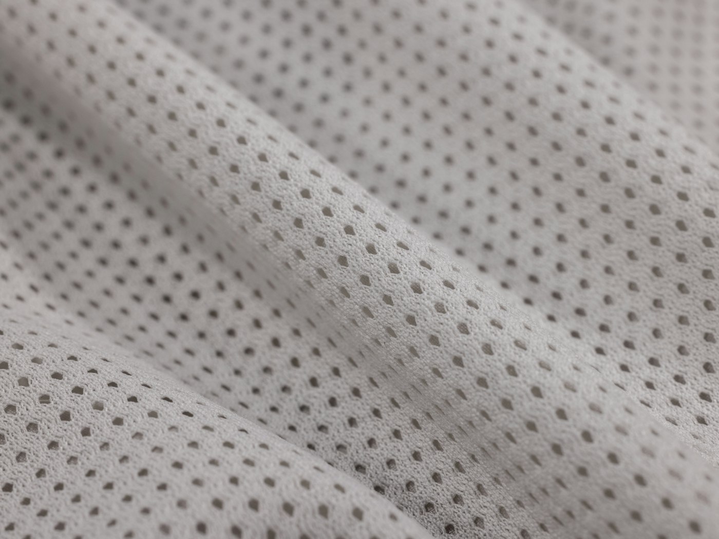 White technical mesh knit fabric folded across itself
