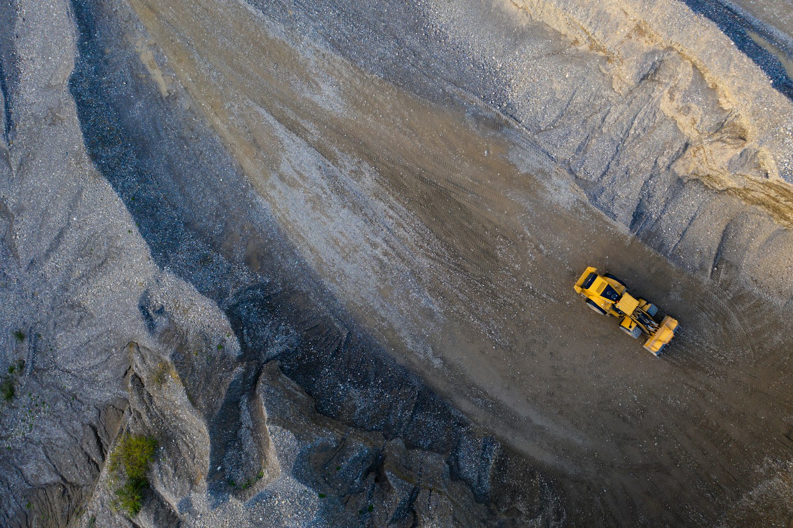 Open‑pit mining operation with excavators and haul trucks working on rock benches