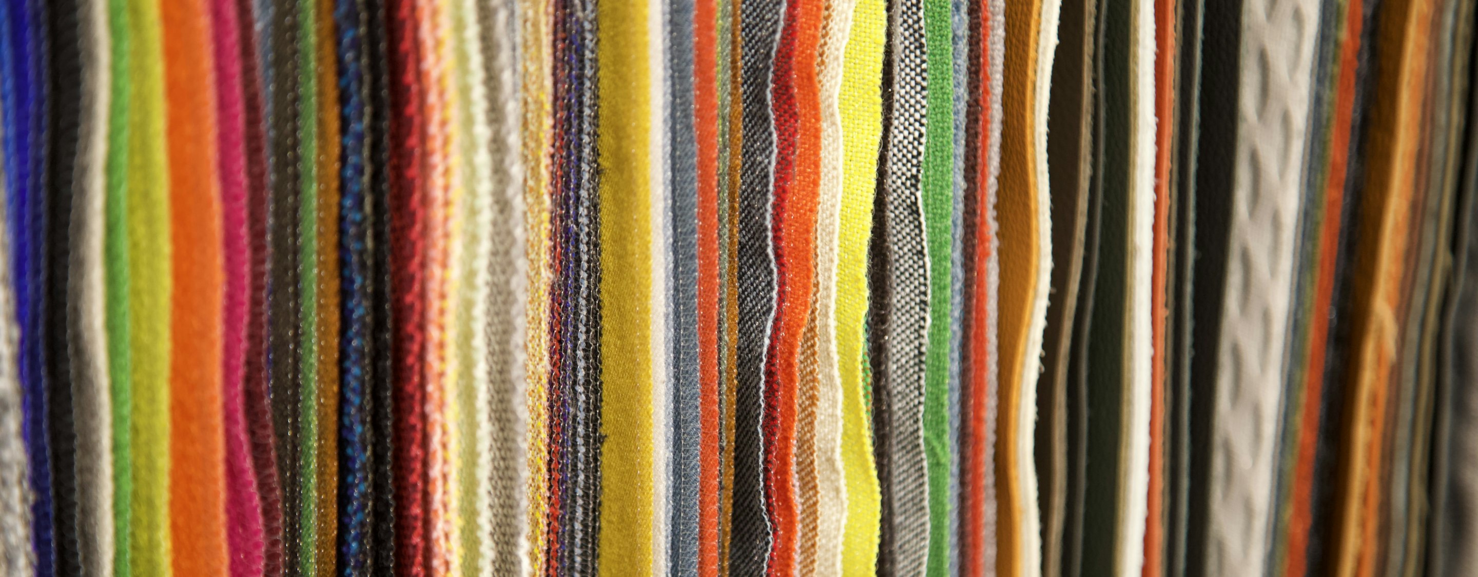 A wall of fabric in many colourways, the range a first assortment is drawn from