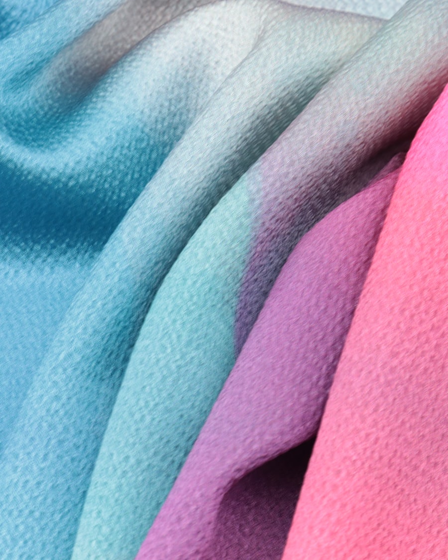 Polyester jersey fabric in team colors — the same fabric base carries both the player cut and the hockey goalie cut