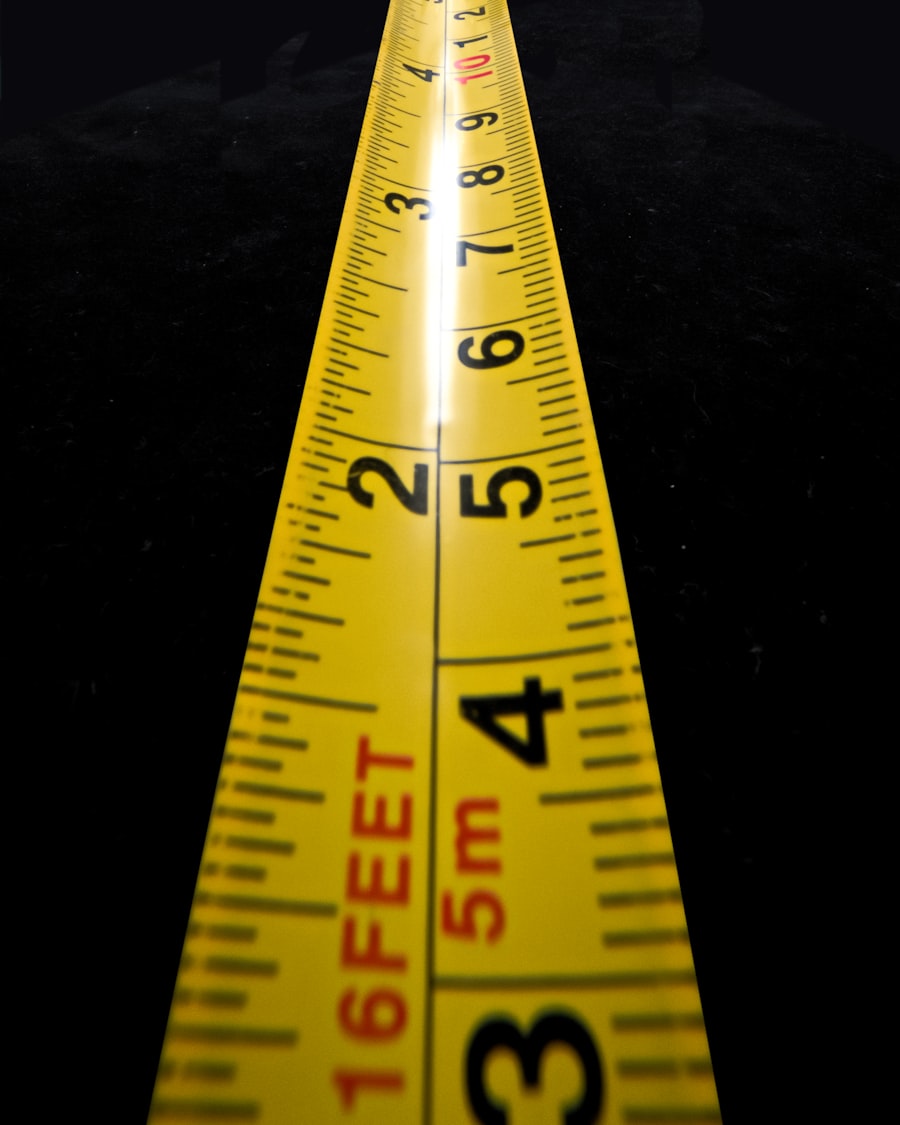 A measuring tape across a graded pattern sheet — the locked measurements everything downstream is checked against