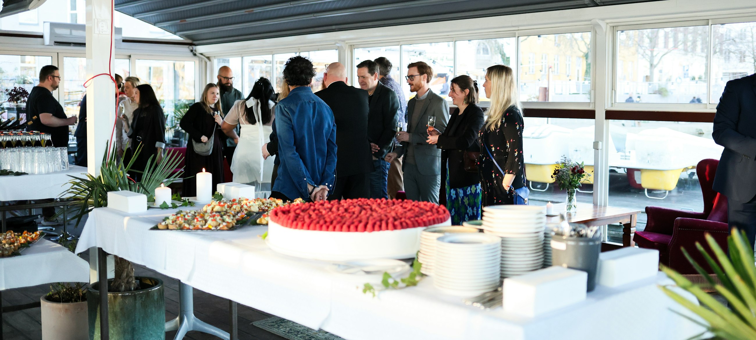 Catering team serving guests on paper plates at an event