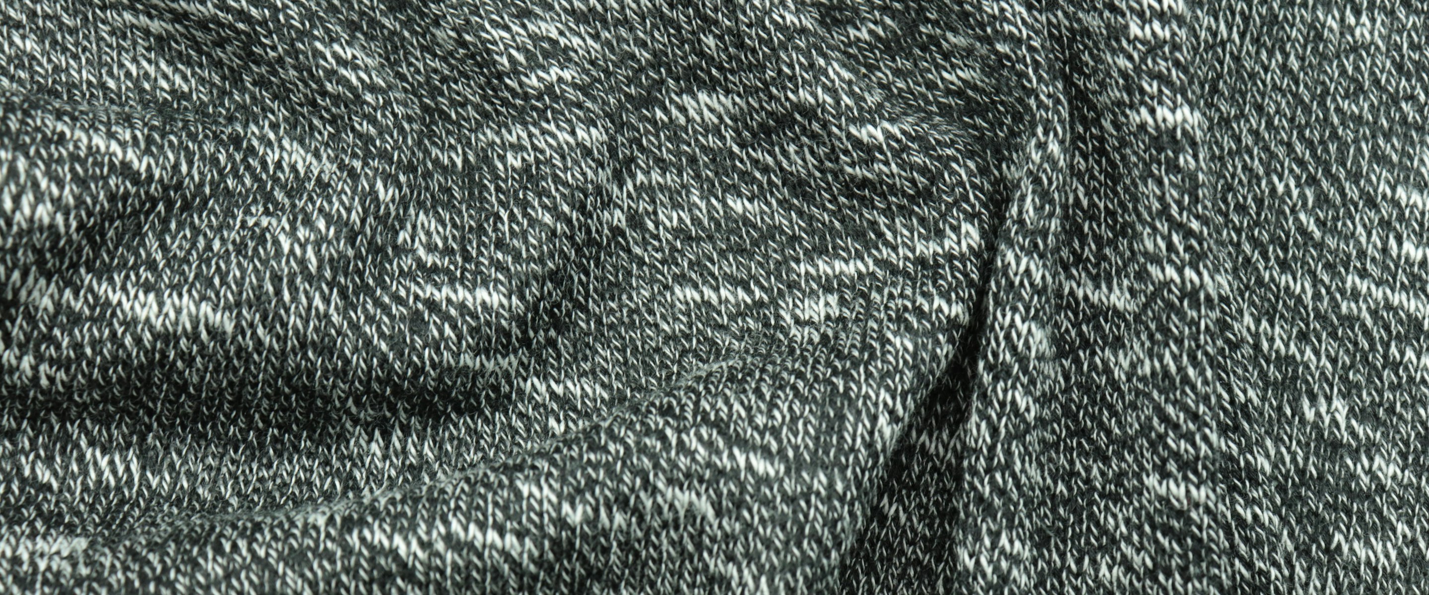 Full-bleed charcoal marl knit fabric, folded