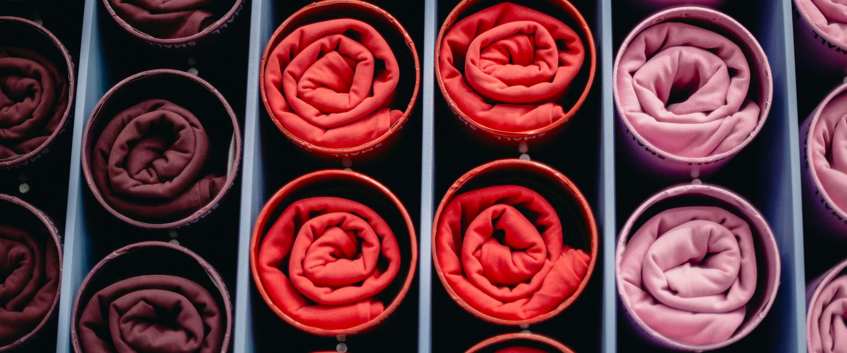 Rolled knit fabric racked on a mill trolley, none of it cut yet