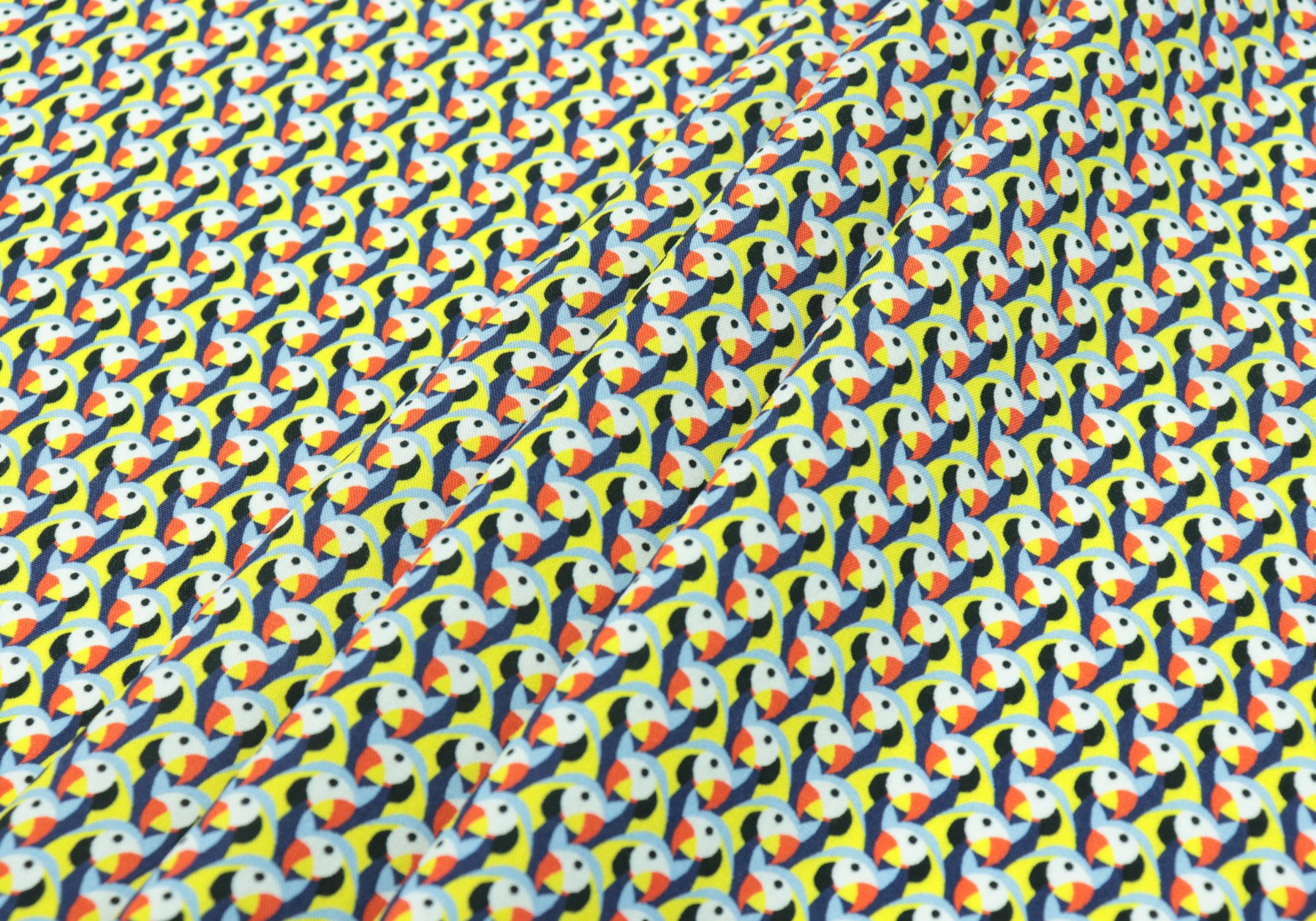 Three neutral reference items arranged for comparison: a fabric swatch, a panel diagram thumbnail, and a color reference chip on a plain work surface.
