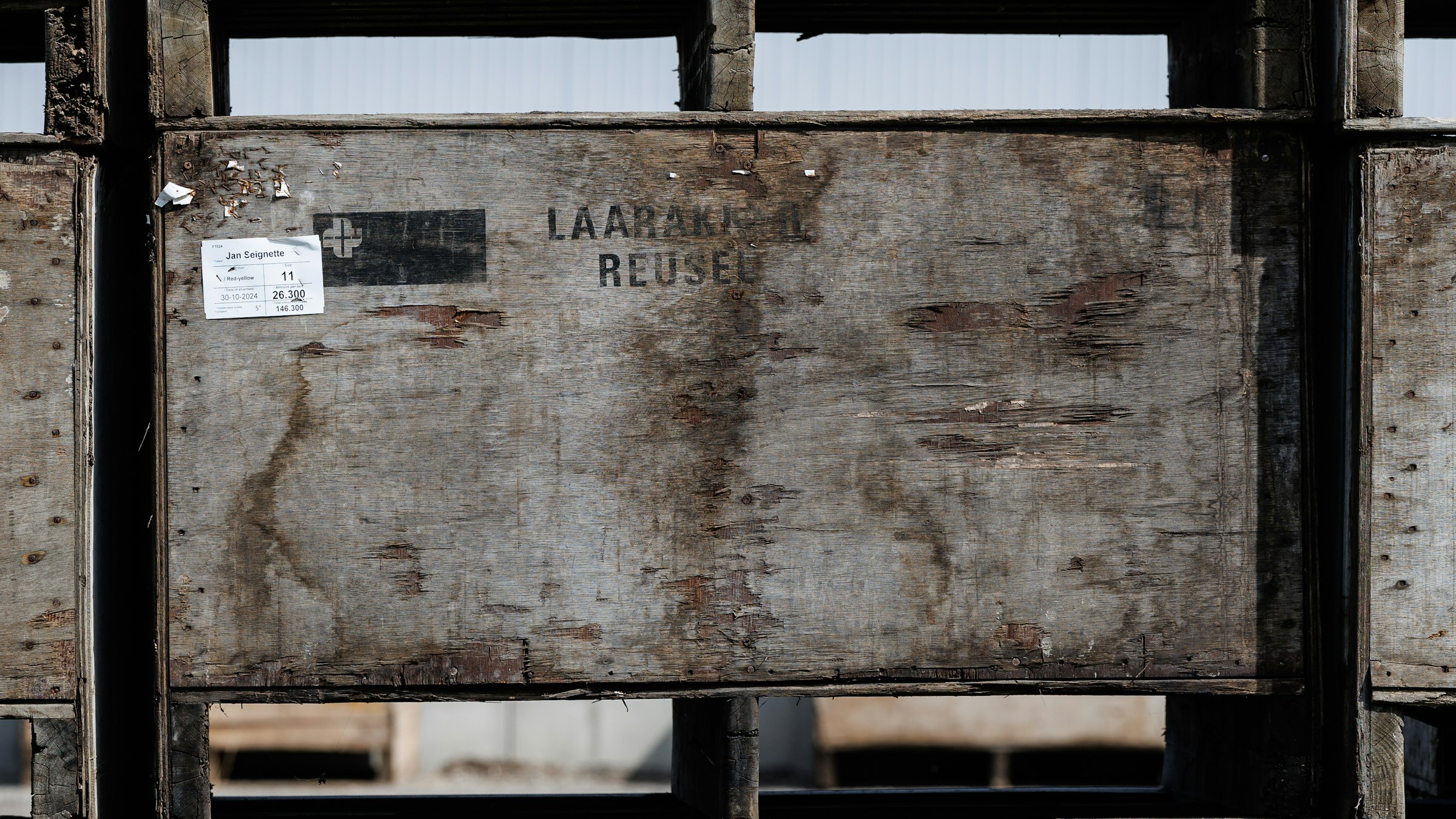 A shipping pallet of boxed hockey jerseys ready for export at a loading dock, generic non-identifying shipping labels.