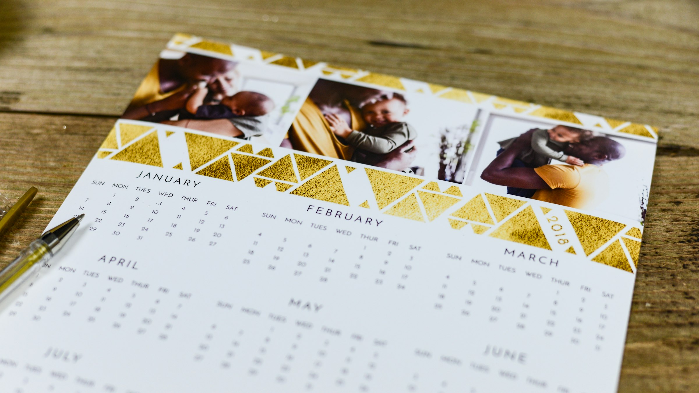 A wall-mounted production schedule board with monthly restock dates marked, a staff member's hand pointing to a marked date.