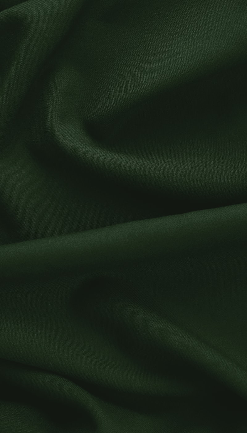 Dark green stretch jersey body fabric draped in soft folds