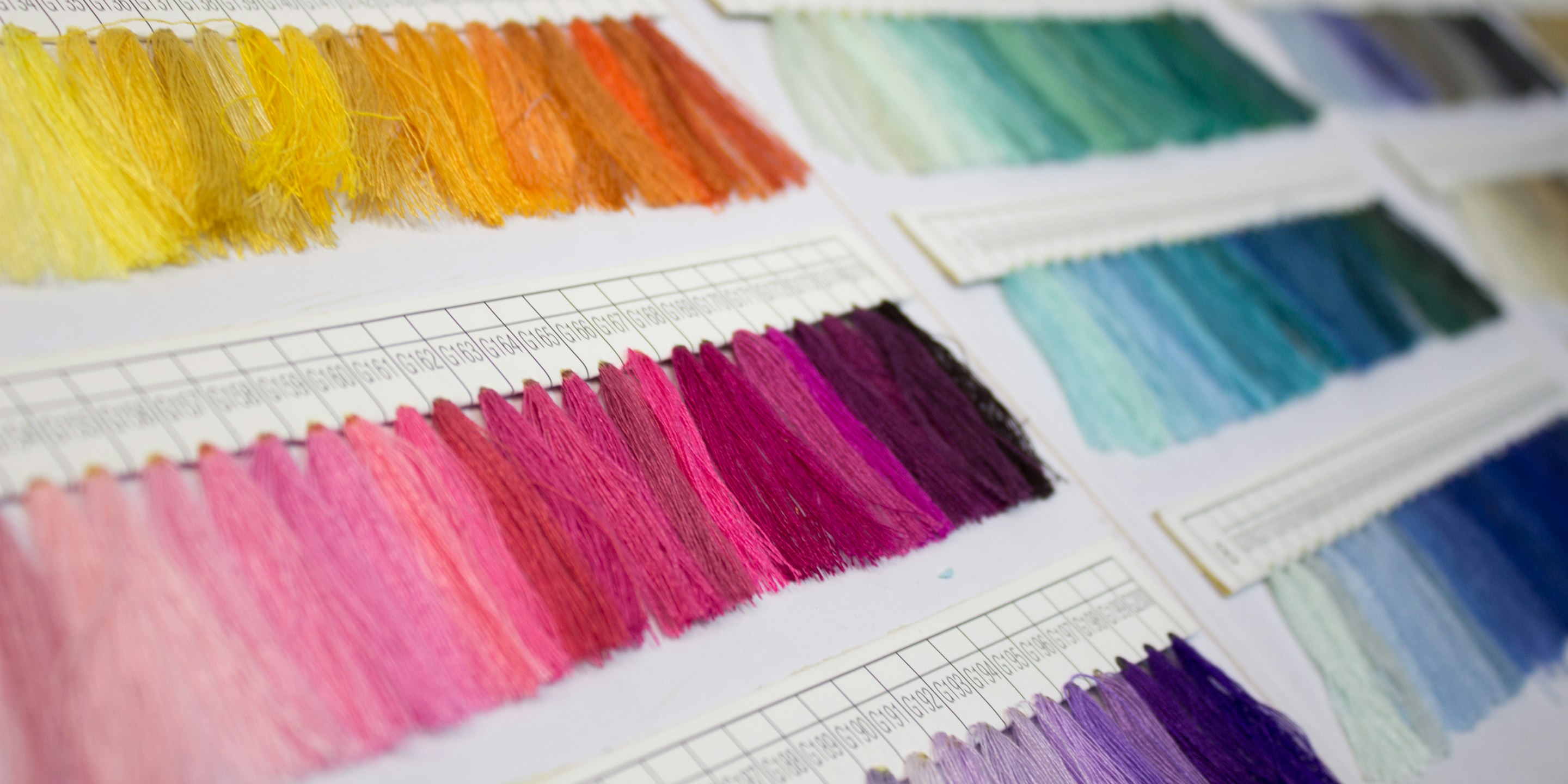 Close-up of folded cycling apparel fabric swatches in a workshop