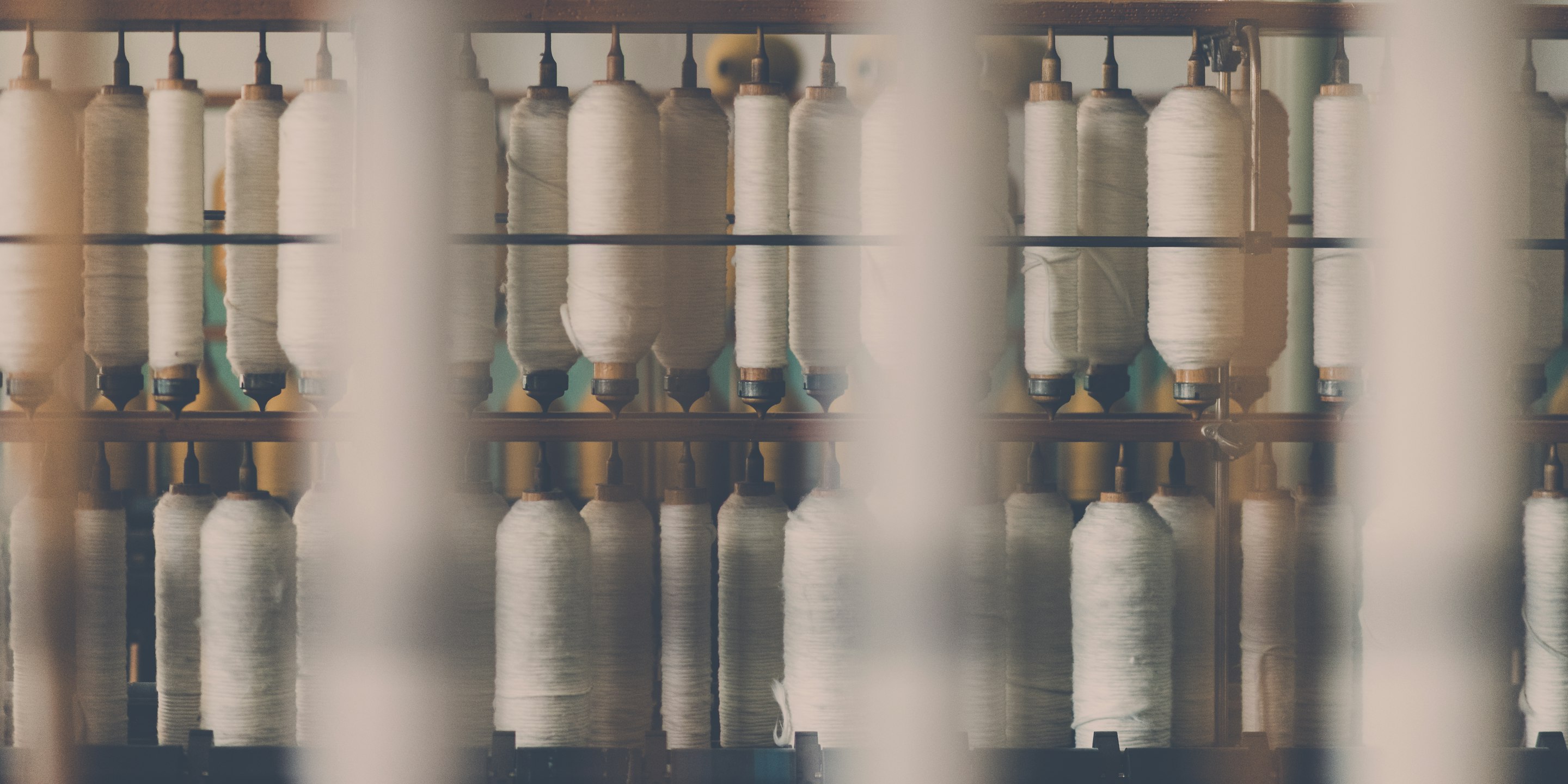 Thread spools on a cycling apparel production line inside a garment factory