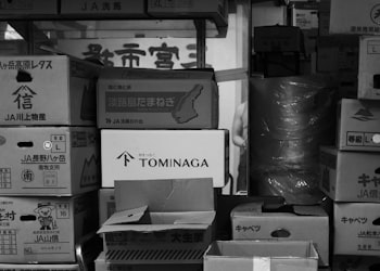 Packing by team: cartons labeled with team and division names stacked for one club