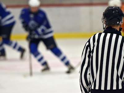 Hockey academy players running a skating drill in matching practice jerseys