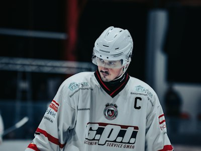 Youth tournament team celebrating on the ice in matching custom jerseys