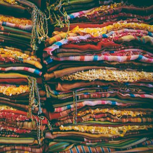 Order quantity factor: stacks of folded team jerseys ready for counting