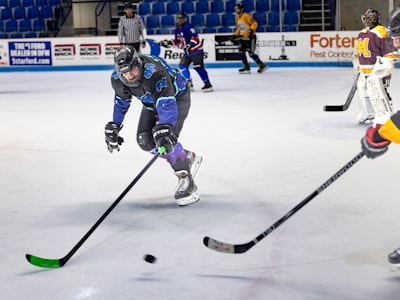 Youth hockey jerseys in lighter air knit fabric hanging on a bench