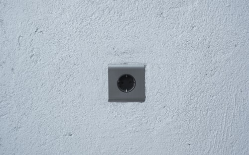 Elderly personal alarm as a wall-mount SOS button by a bathroom