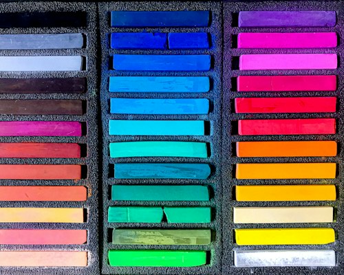 Pantone color reference cards beside dyed polyester fabric swatches for a hockey jersey lab dip