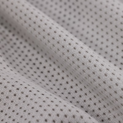 Close-up of a breathable mesh lining fabric inside a warm-up jacket