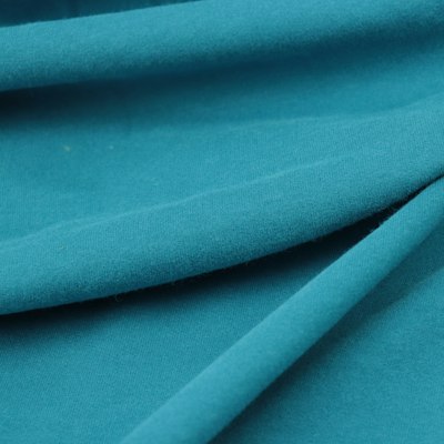 Close-up of a lightweight woven shell fabric used for warm-up jackets