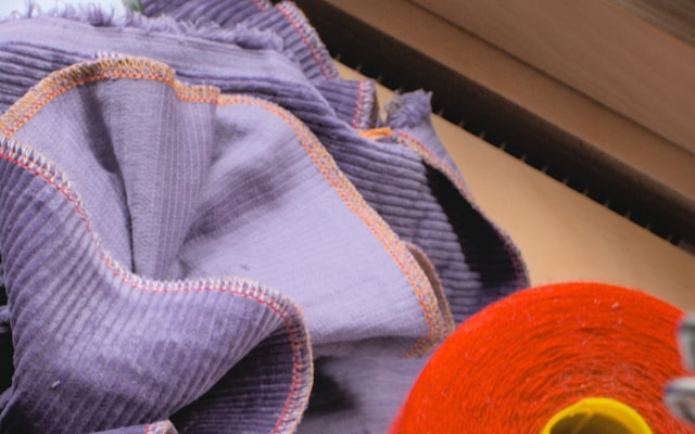 Bartack stitching reinforcing the zipper base at a hockey pant shell leg opening