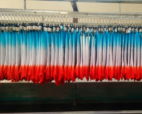 Pre-production sample jersey being checked against an approved specification sheet