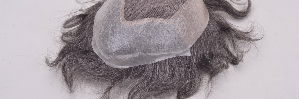 Custom wig production line at Source Wigs factory — workers at specialized stations for ventilation, coloring, and QC