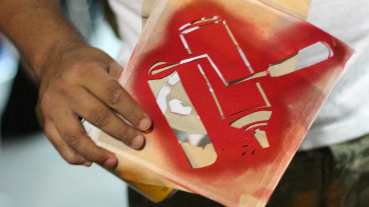 Screen printing squeegee pulling ink across a mesh screen onto a work shirt back