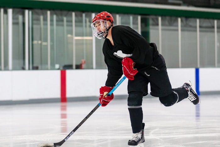 A full hockey uniform laid out together: jersey, socks, and pant shell in one fictional colorway