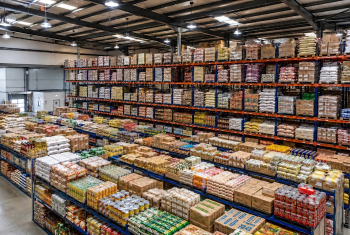 Standing restock cartons for a distributor account on warehouse shelving