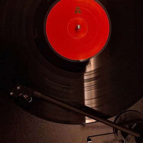 Vinyl record spinning with neon reflections