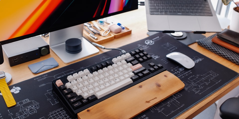 A clean workspace with a notebook and laptop