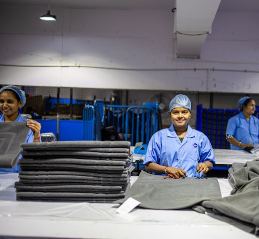 QC inspection — worker checking finished product against the approved reference sample