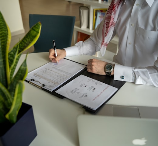 Certification documents and sample approval paperwork on desk