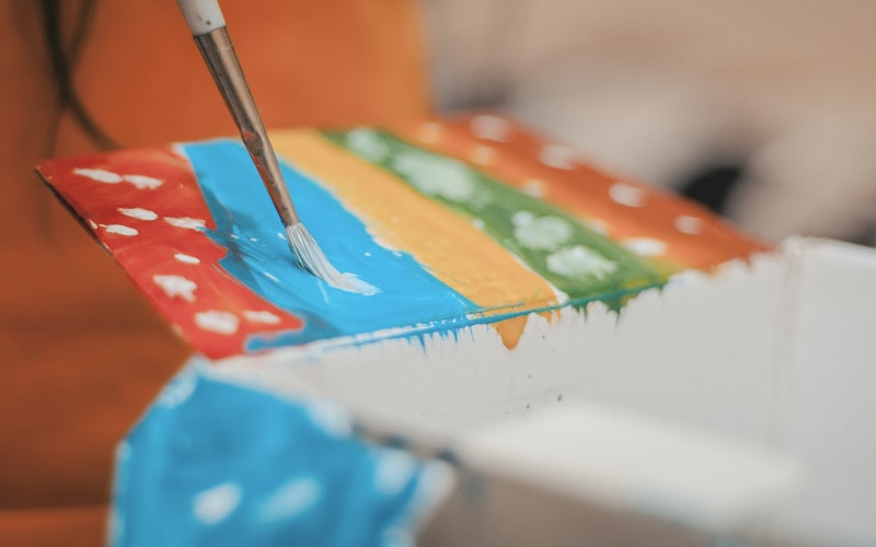 Essential flag making materials and tools including 200-300D polyester fabric, UV-resistant thread, fabric scissors, measuring tape, sewing machine, grommets, and outdoor fabric paint for DIY custom flag construction