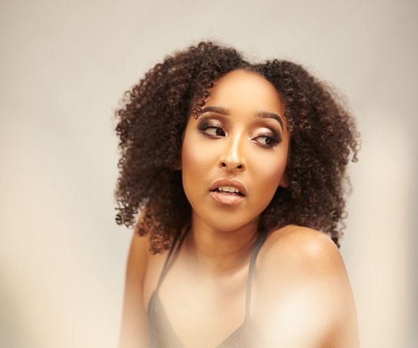 Woman with natural hair wearing U-Part wig showing seamless blend