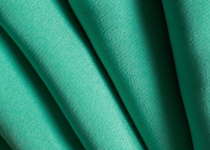 Macro of open mesh polyester fabric used for vented side inserts on a hockey pant shell