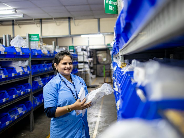 Logistics team member in a royal blue pique work polo with an embroidered logo