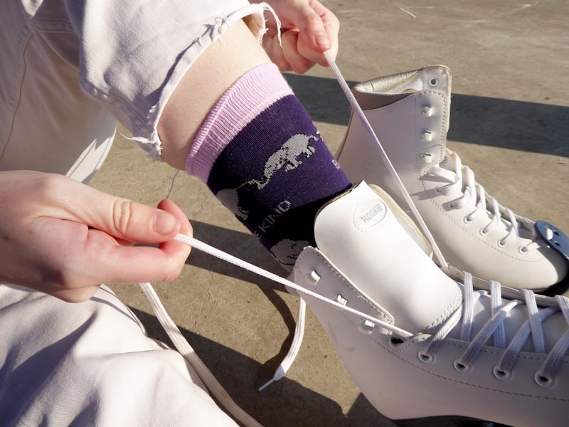 Cut-and-sew hockey socks in a red and black fictional team colorway with striped leg pattern, product shot