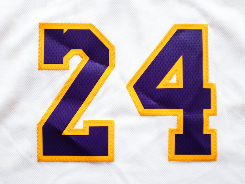 Tackle twill crest and stitched numbers on a women's hockey jersey