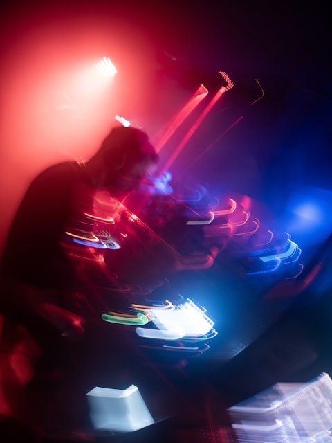 DJ performing with neon lights in background