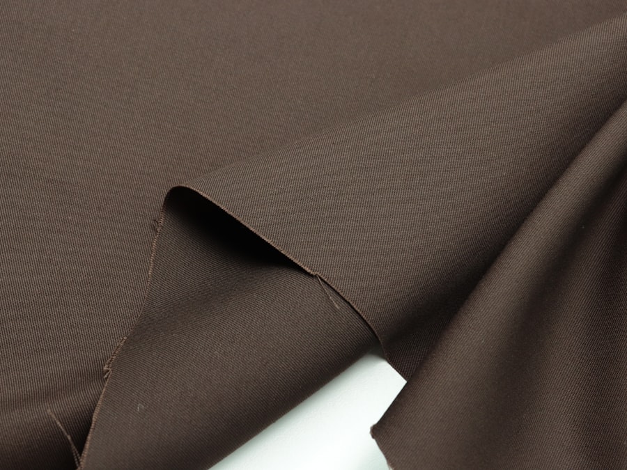 Double-knit polyester — the dense standard practice body at 200–220 gsm
