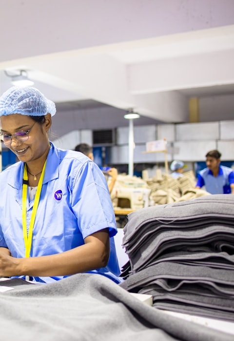Sewing workshop — workers at sewing stations on the production floor