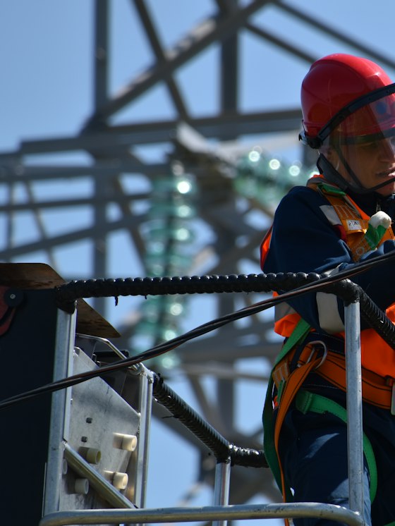 Road crew member in a fluorescent orange long sleeve Class 3 hi-vis shirt