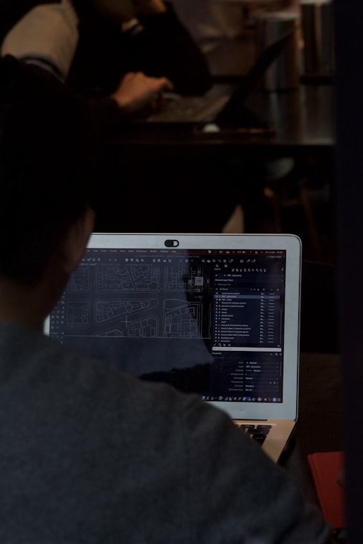 Developer at desk coding mobile app in a modern workspace