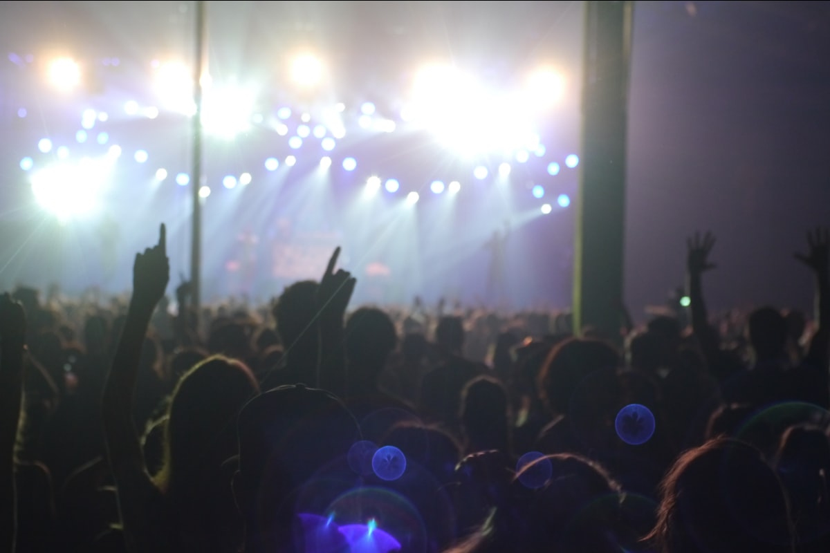 Crowd at concert with neon stage lights