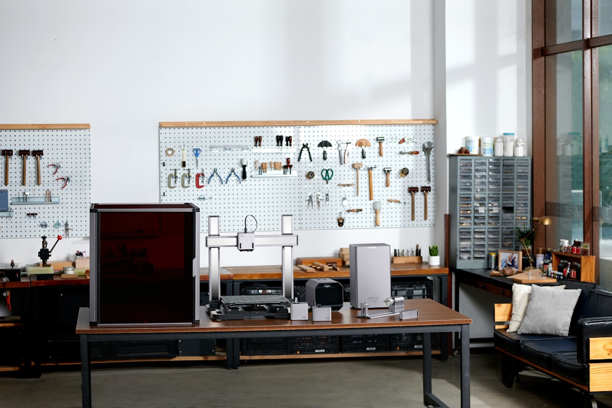A factory production line and in-house parts shelves — the factory-direct chain behind a company's wall-printing service line